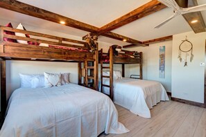 A bunk bed room with wooden beams, white bedding, and a dreamcatcher on the wall. - Beaver Run Resort Ski-in/Ski-out & walk to Main St (Breckenridge)