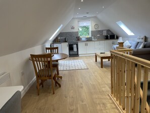 A modern loft apartment with a dining area, kitchen, and living space. - Rural Apartment, Near Spalding, 1 bed (Spalding)