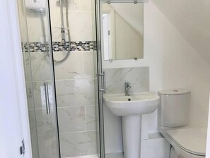 A modern bathroom with a glass-enclosed shower, a white sink, and a toilet. - Rural Apartment, Near Spalding, 1 bed (Spalding)