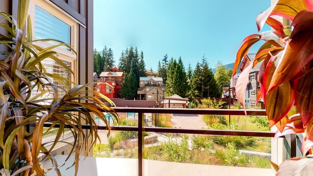 A balcony with a view of a residential area, including houses and trees. - Lake Placid Lodge by Whistler Premier (Whistler)
