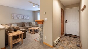 A living room with a sofa, coffee table, and a fireplace. - Lake Placid Lodge by Whistler Premier (Whistler)
