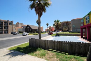 Stroll through a charming neighborhood lined with modern homes and apartment complexes.