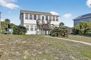 A two-story house with a wooden staircase leading to the upper floor. - Oceanfront Getaway - Private Boardwalk, Enclosed sun porch (Folly Beach)