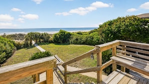 A wooden deck with a view of the beach and ocean. - Oceanfront Getaway - Private Boardwalk, Enclosed sun porch (Folly Beach)