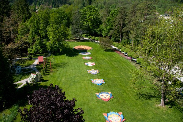 A well-maintained lawn with a series of colorful, circular flower beds arranged in a line.