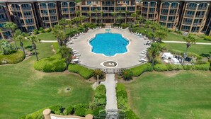 A hotel with a central pool surrounded by palm trees and a sign reading "Mediterranea". - The ONLY 1 Bedroom with a private Bunk Room - Beach Service Included!!! (Miramar Beach)