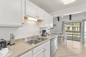 Enjoy cooking in this well-lit kitchen with stainless steel appliances and a large island.