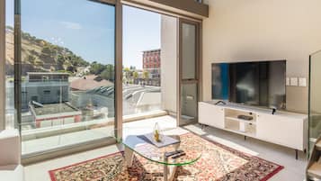 Luxury Apartment, 1 Bedroom, Kitchen, Mountain View | Living area | 55-inch Smart TV with cable channels, TV, Netflix