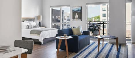 Studio, 1 Queen Bed (Studio Apt Designer Furnished) | Desk, laptop workspace, iron/ironing board, bed sheets