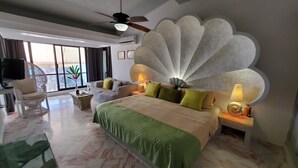 A hotel room with a large bed, a ceiling fan, a TV, and a view of the outdoors. - VillaParaisoAca,  With Beautiful View & Private Beach.  Christmas Special. (Acapulco)