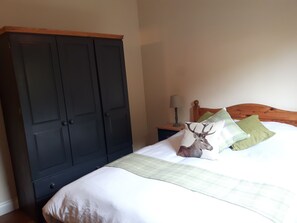 A bedroom with a bed, a nightstand, a lamp, and a wardrobe. - Ever Wanted to go off Grid,then This is for you (Sutton Coldfield)