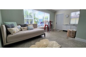 Cozy living space with a sofa, table, and chair, perfect for relaxing.