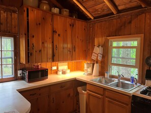 Fridge, microwave, oven, stovetop - Quaint and cozy log and knotty pine cabin close to lakes. (Harrison)