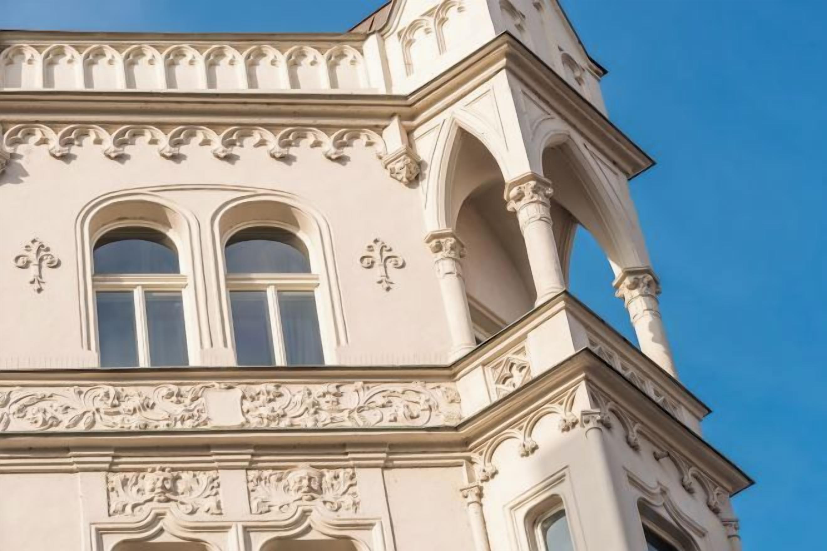 A building with ornate architectural details, including arched windows and decorative moldings.
