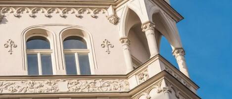 A building with ornate architectural details, including arched windows and decorative moldings.