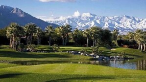 A golf course with a mountain backdrop. - Mid-Century Private PoolSpa GolfResort LushGardens (New York)