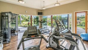 A gym with treadmills, a stationary bike, and weight machines.