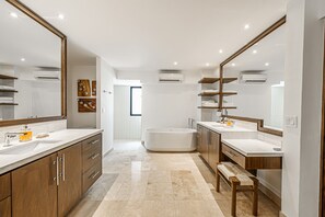 Bathtub, hair dryer, bathrobes, towels