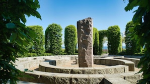 A stone monument surrounded by a circular stone pathway. - Terrace, free use of the AHOI adventure pool and sauna - Sea view apartment 78 - (Göhren)