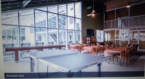 Relax and socialize in this open recreation area, featuring a ping pong table and comfortable seating.