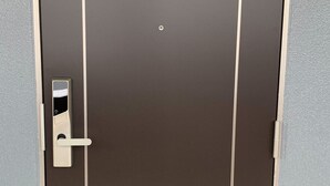 A door with a keyhole, a handle, and a rectangular panel. - HOTEL ARENA (Chatan)