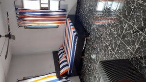 A room with a marble floor, striped curtains, and a ceiling fan. - Impeccable 3-Bed Apartment Located in Lagos (Lagos)