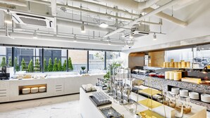 A modern kitchen with a marble floor, large windows, and a variety of kitchen appliances and utensils. - Shift Door Residence Hari (Busan)