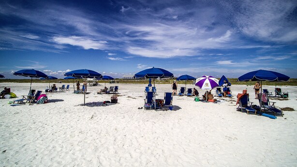 A beach with multiple umbrellas and sun loungers. - Beach Life Condo 135. Pools! Beach! Casinos! FUN! (Biloxi)