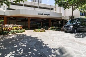 A building with a sign reading "walkk banyan" and a Mercedes-Benz van parked in front.