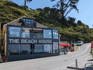 A two-story building with a sign reading "The Beach House." - Keepers Cottage (Liskeard)