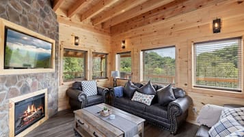 Cabin, 5 Bedrooms | Living room | 65-inch Smart TV with cable channels