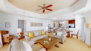 A spacious living room with a sofa set, coffee table, and a ceiling fan. - Cozy Condo with Third Floor Balcony at Reunion (Kissimmee)