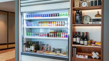 A refrigerated display case with beverages and wine bottles.