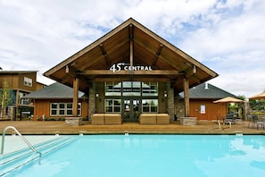A building with a sign reading "45 CENTRAL" above the entrance, a pool in the foreground, and outdoor seating areas. - Exceptional Location & Vibes, New Décor, Artwork, & Furnishing, Community Pool, 8 Miles to Portland (Beaverton)