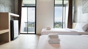 A hotel room with two beds, a wardrobe, and a balcony with a city view. - B2 Chiang Rai Phahonyothin Boutique & Budget Hotel (Chiang Rai)