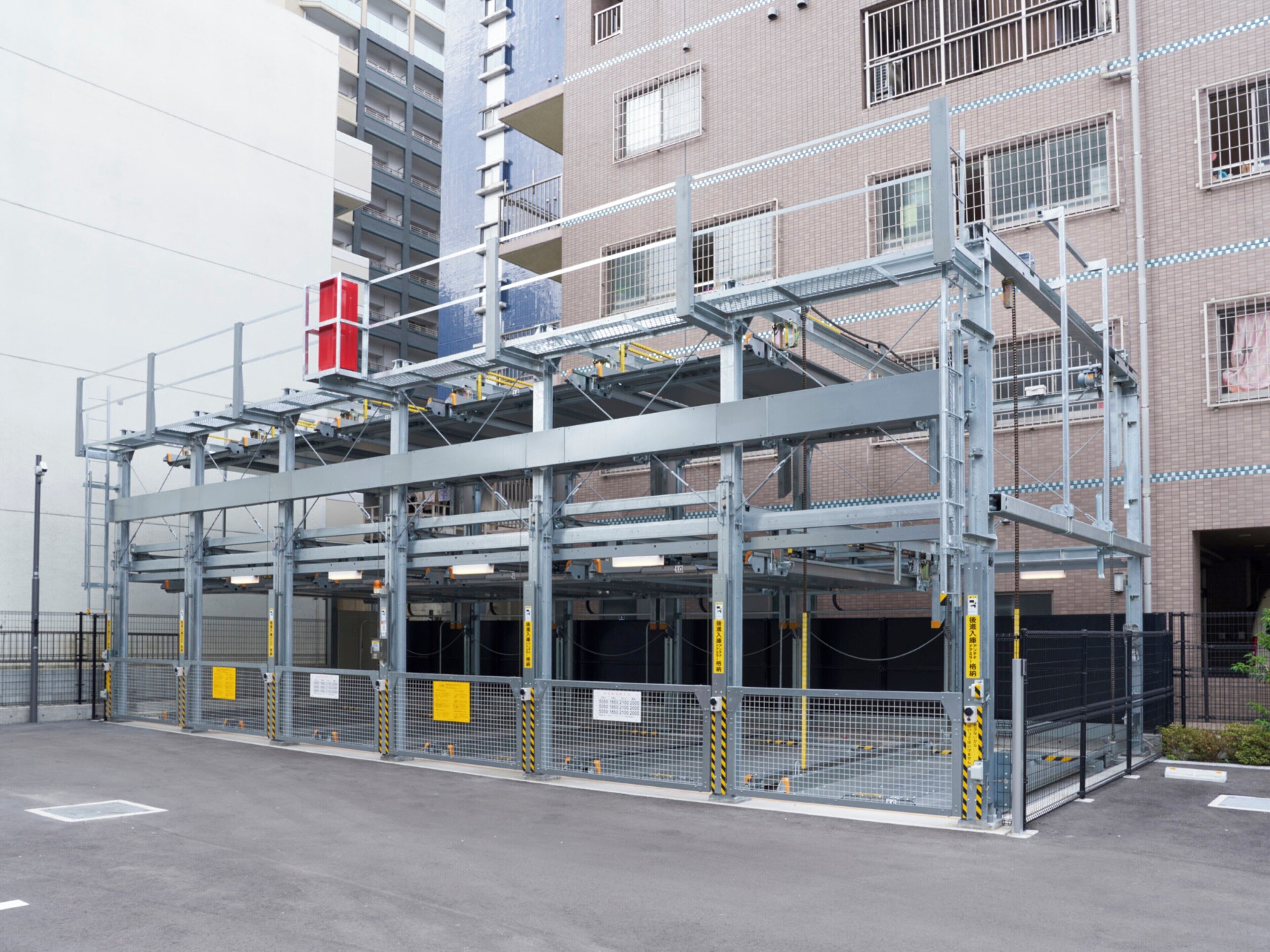 A multi-level parking structure with a metal framework and yellow safety barriers.
