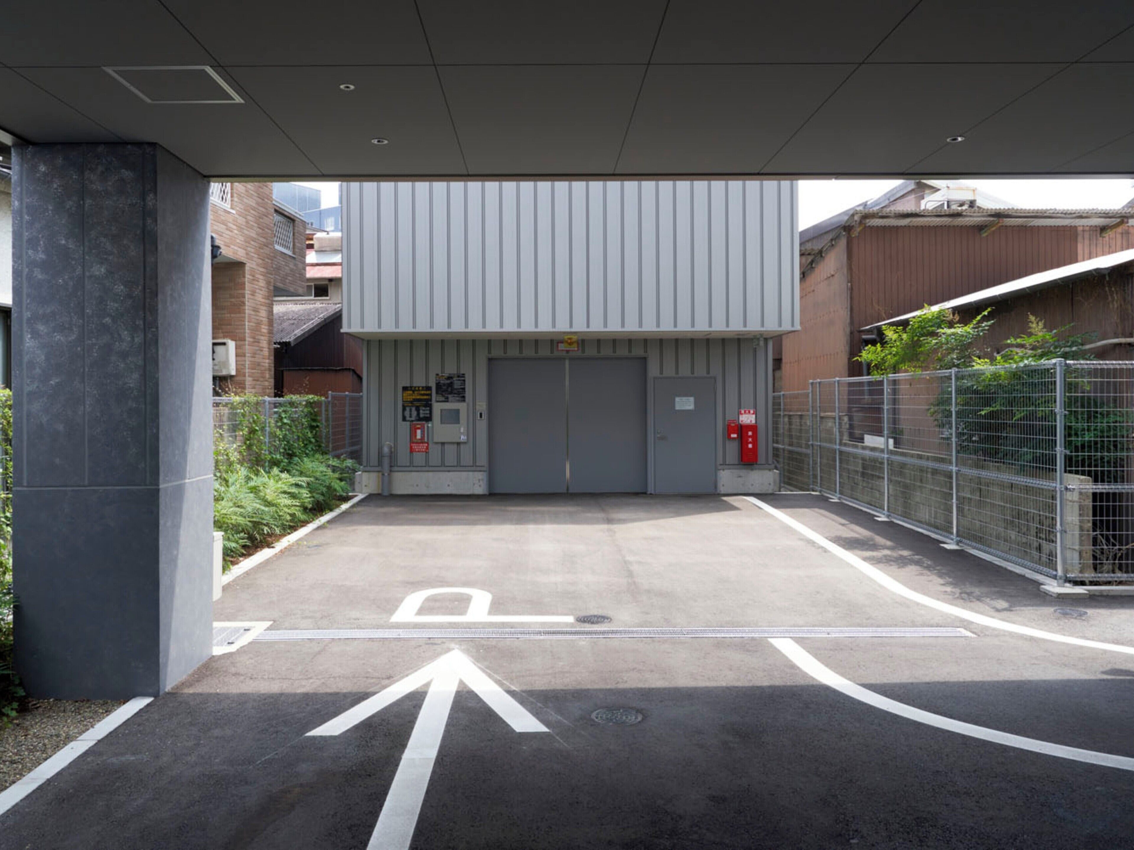 A parking area with directional arrows and a gated entrance.