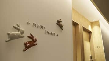 A wall with directional arrows and numbers indicating room locations.