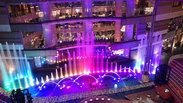 A multi-level building with a central fountain and surrounding lights.