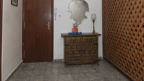 A wooden door, a mirror, a cabinet, and a lattice partition in a hallway. - SAINT GERMAIN, A-2º-4 (Cullera)