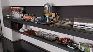 A modern kitchen with a coffee machine, tea dispensers, and various food items on the counter. - Hotel de Cerva (Ribeira de Pena)