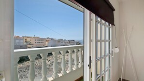 Un balcón con vistas a edificios y un cielo despejado.