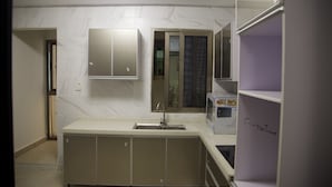 A kitchen with a built-in sink, cabinets, and a countertop. - Residence Ministre (Abidjan)