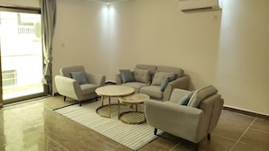 A modern living room with a sofa set, a coffee table, and a small round table. - Residence Ministre (Abidjan)