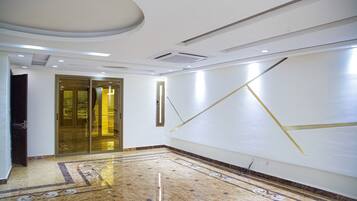 Experience the sleek, modern design of this stylish hallway, featuring a polished floor and elegant glass door.