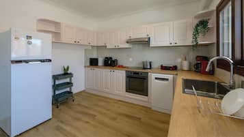 Full-sized fridge, oven, electric kettle, cookware/dishes/utensils