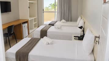 A hotel room with two beds, a desk, a chair, a TV, and a balcony with curtains.