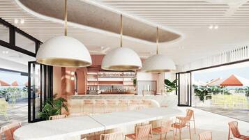 A modern bar area with a long counter, multiple hanging pendant lights, and a view of the outdoors.