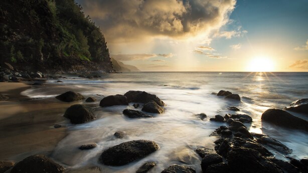 A beach with rocks and a sunset. - Banyan Harbor #F71, Walk to Beach, Wifi, AC, Pool, Parking, Laundry (Lihue)