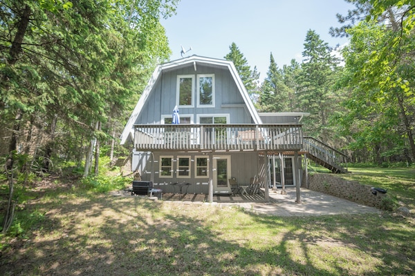 Back side of the cabin with deck and patio.